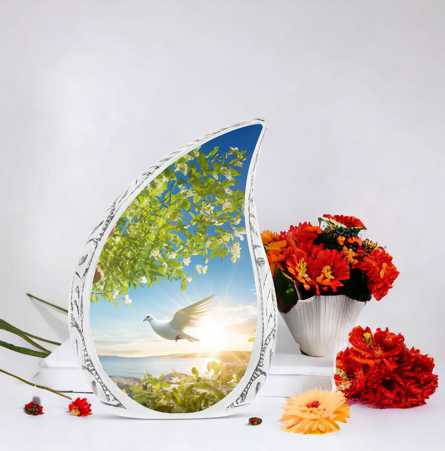 Large dove urn designed with a dove flying close to a tree, a unique cremation urn for women and a distinctive mosaic urn for human ashes