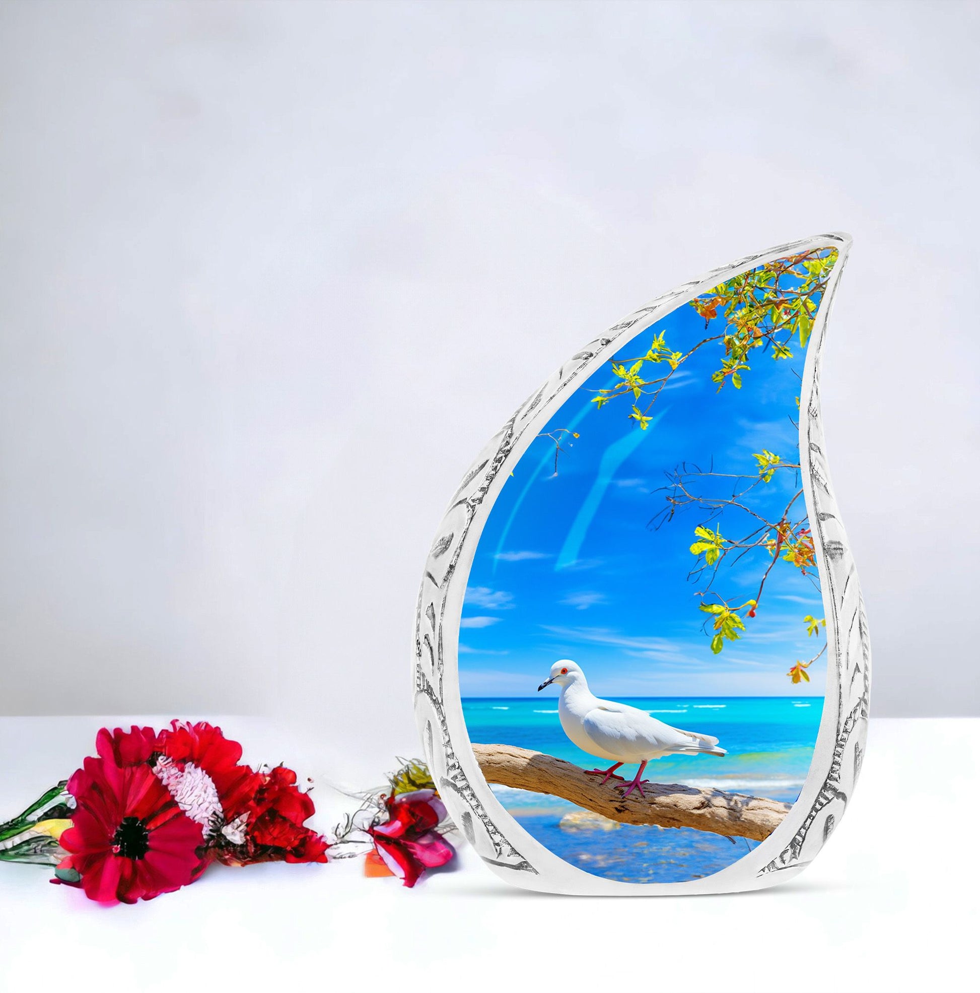 Large Dove Urn set against the backdrop of tree and ocean, unique burial urn for adult human ashes