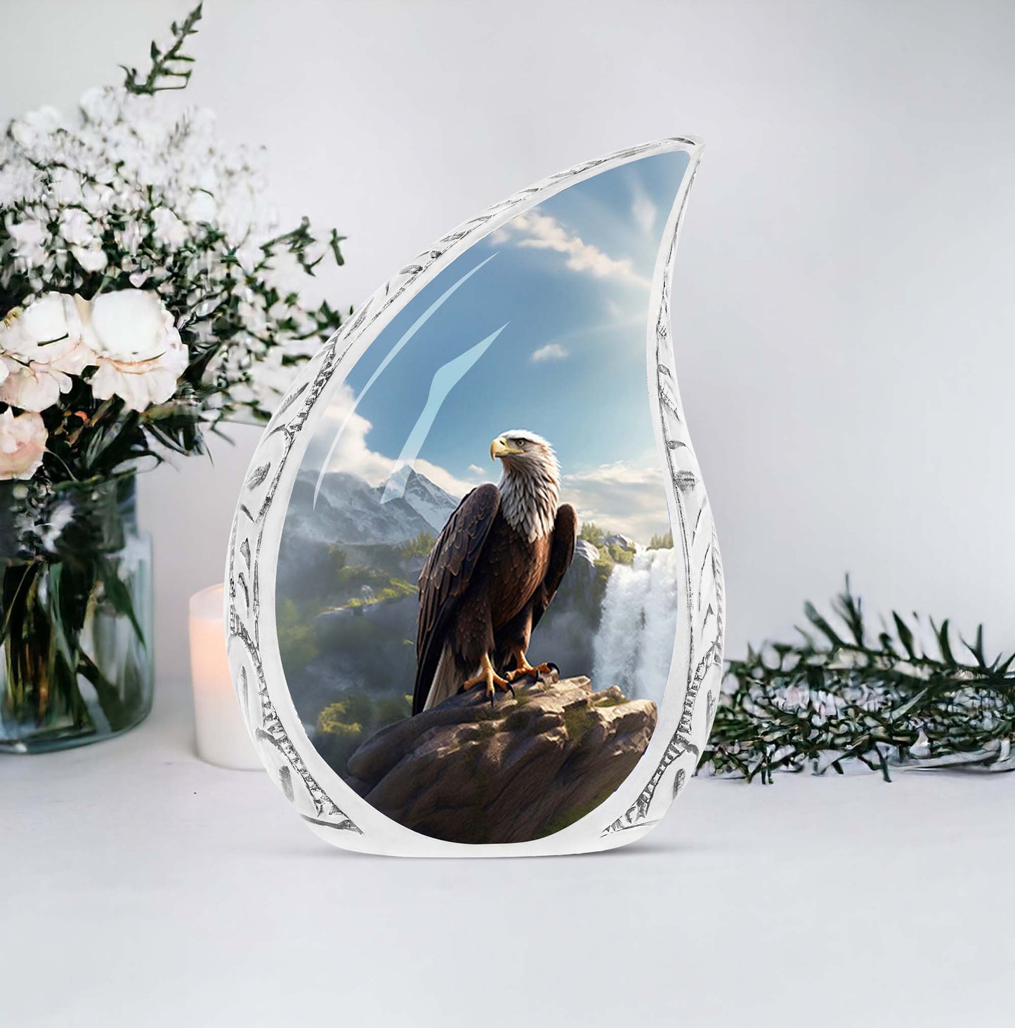 Large eagle-themed urn for human ashes, sitting by a waterfall, made of decorative metal
