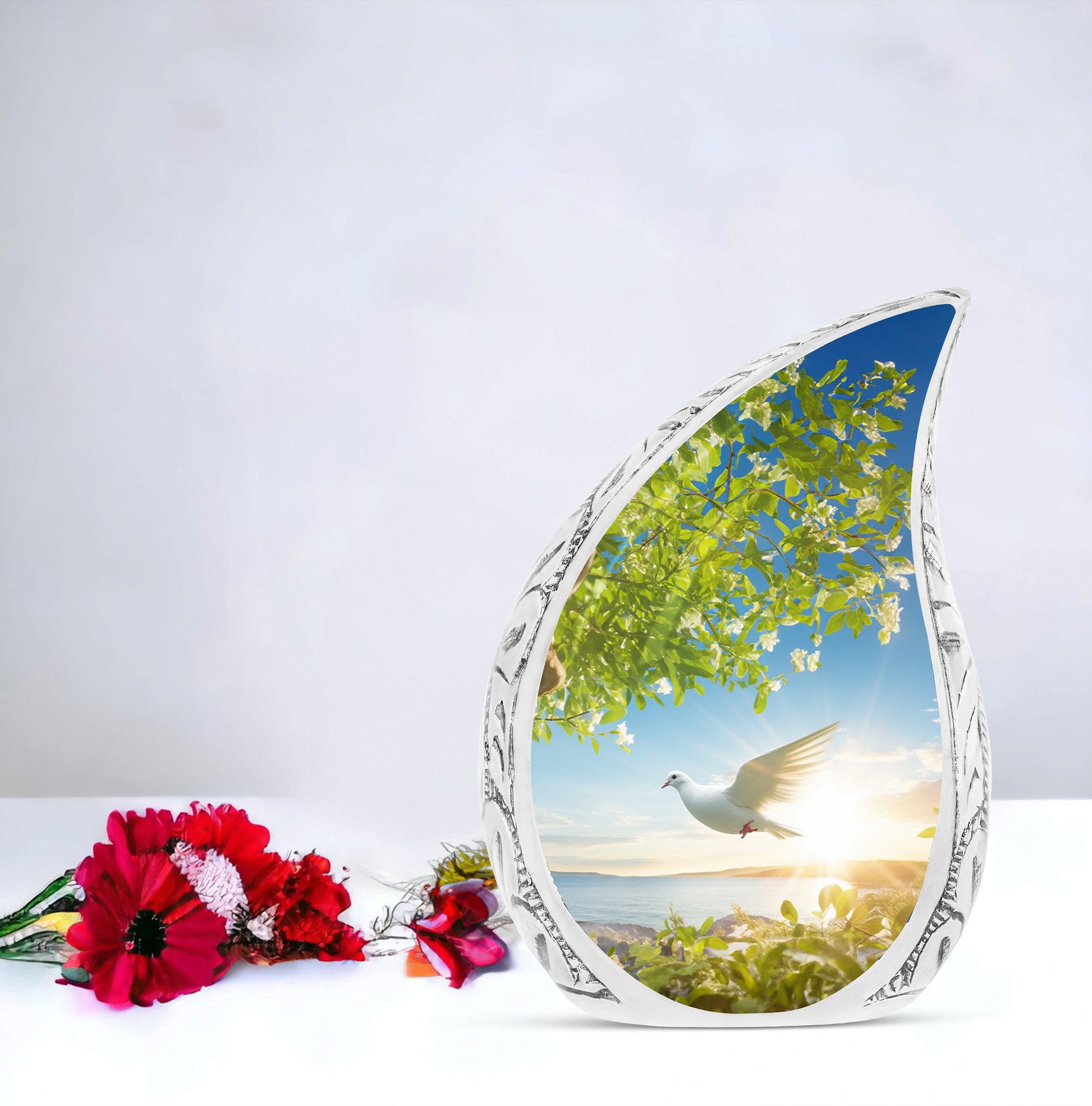 Large dove urn designed with a dove flying close to a tree, a unique cremation urn for women and a distinctive mosaic urn for human ashes