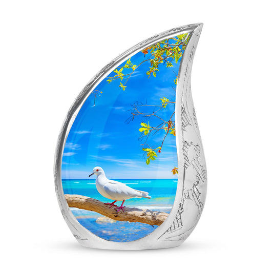 Large Dove Urn set against the backdrop of tree and ocean, unique burial urn for adult human ashes