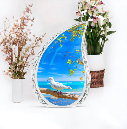 Large Dove Urn set against the backdrop of tree and ocean, unique burial urn for adult human ashes
