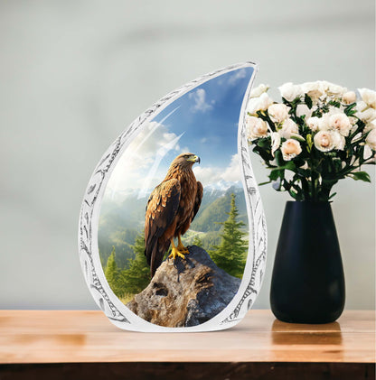 Portrait of an eagle perched on a large, stone urn designed for adult human ashes