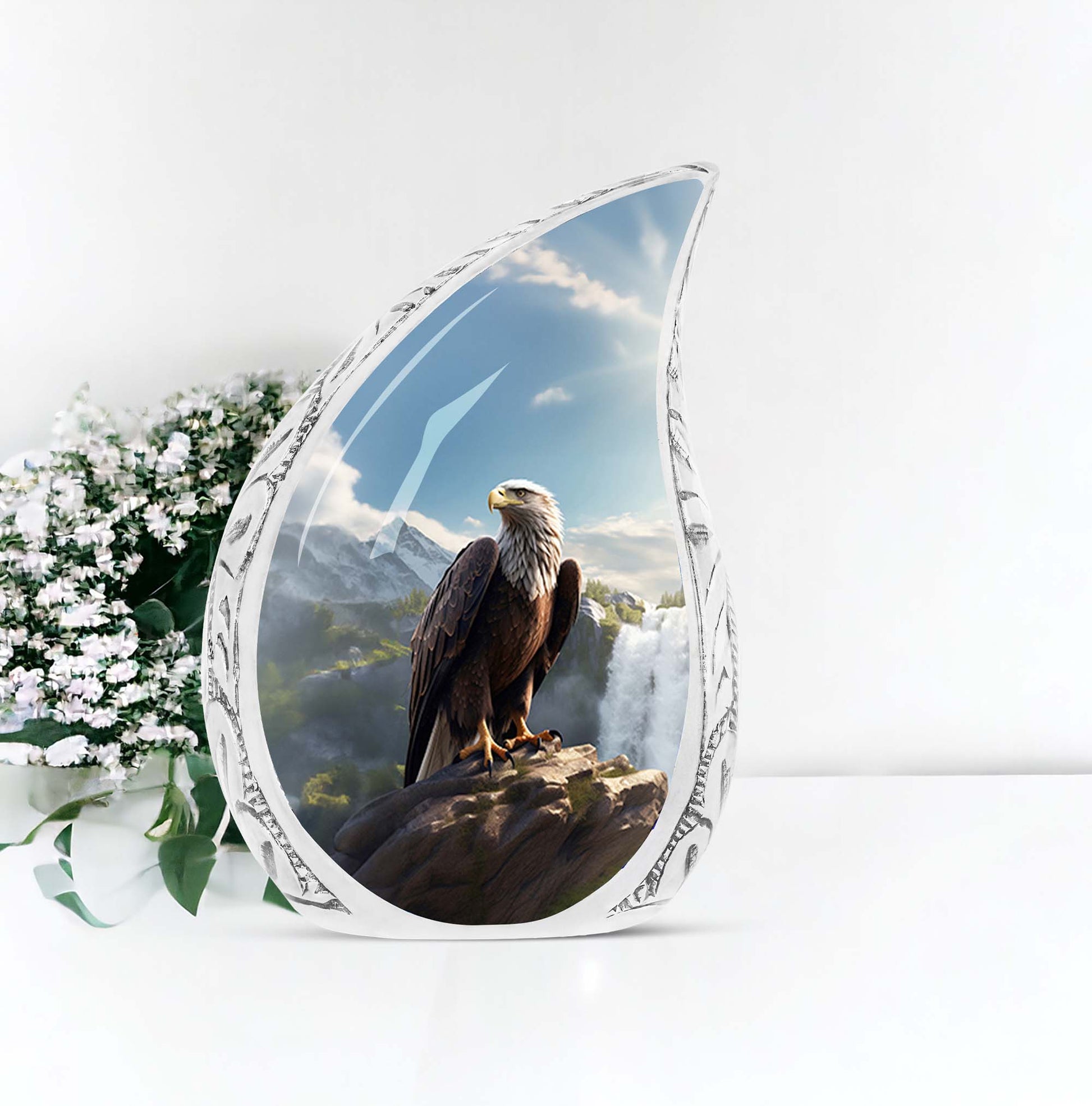Large eagle-themed urn for human ashes, sitting by a waterfall, made of decorative metal