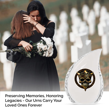 Large metal burial urn for adult ashes featuring a gold crown on a skull design, suitable for men